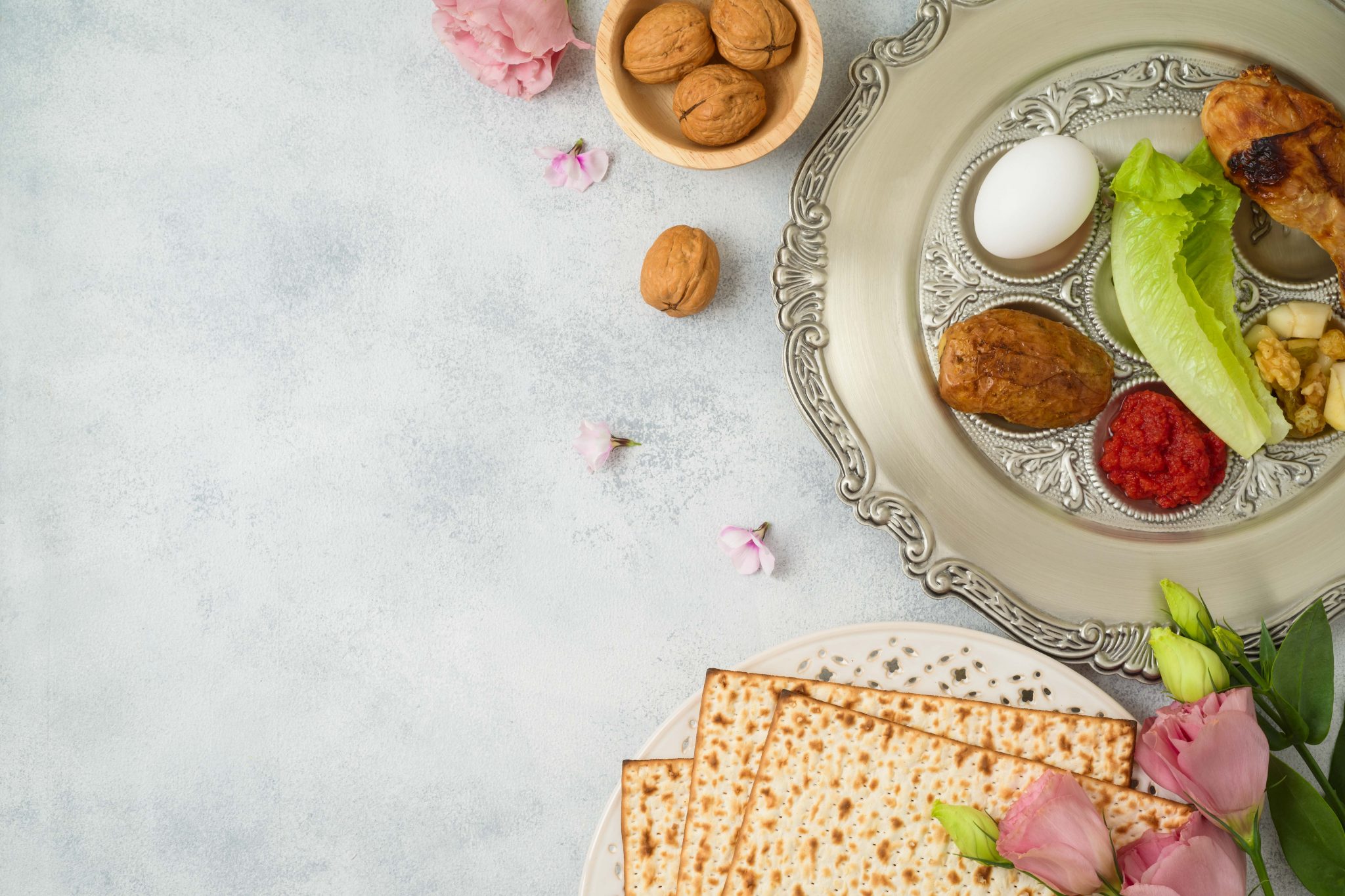 Jewish holiday Passover background with matzo, seder plate and spring